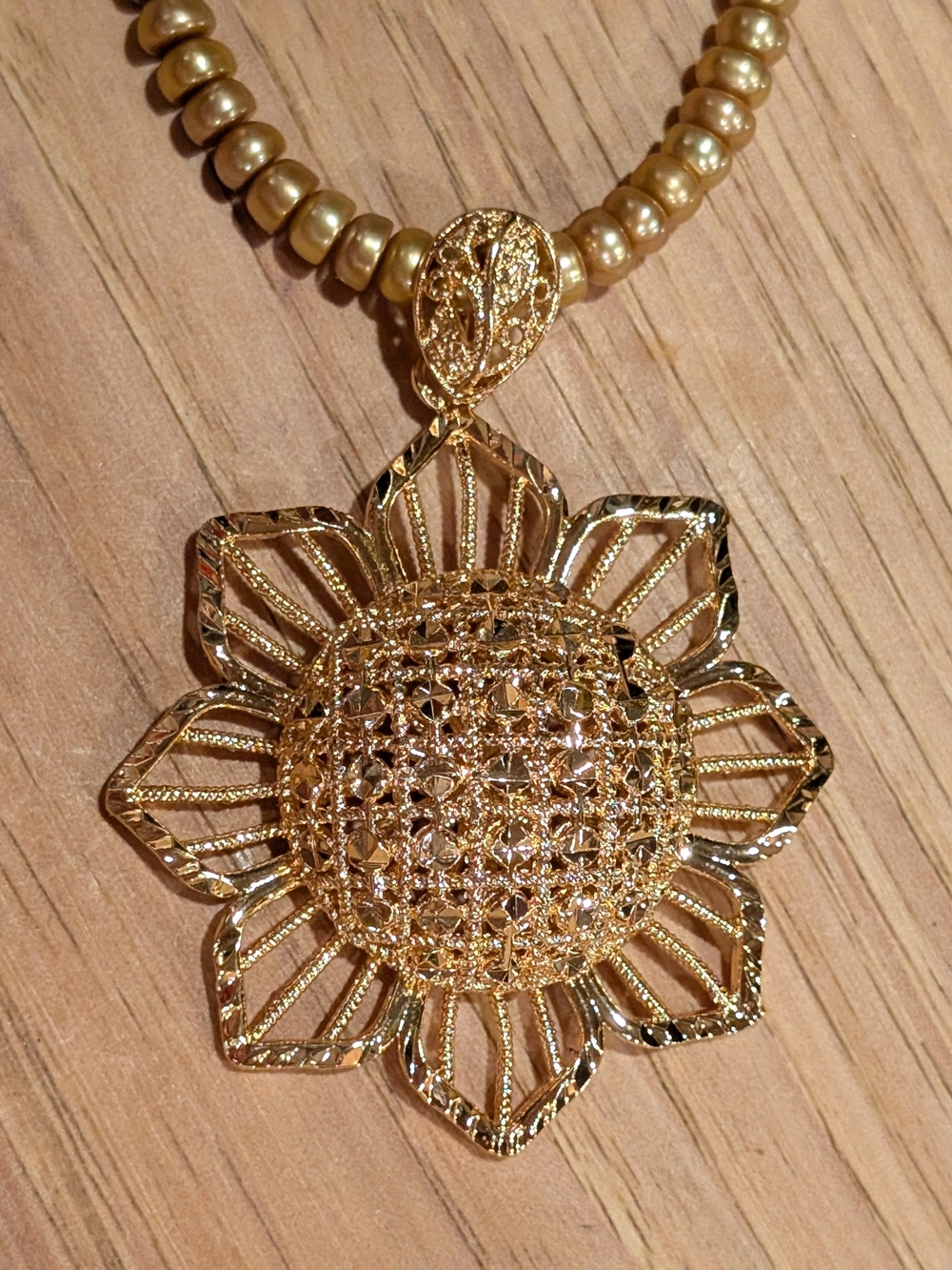Diamond Cut Goldtone Sunflower Pendant On Natural Gold Pearl Necklace.